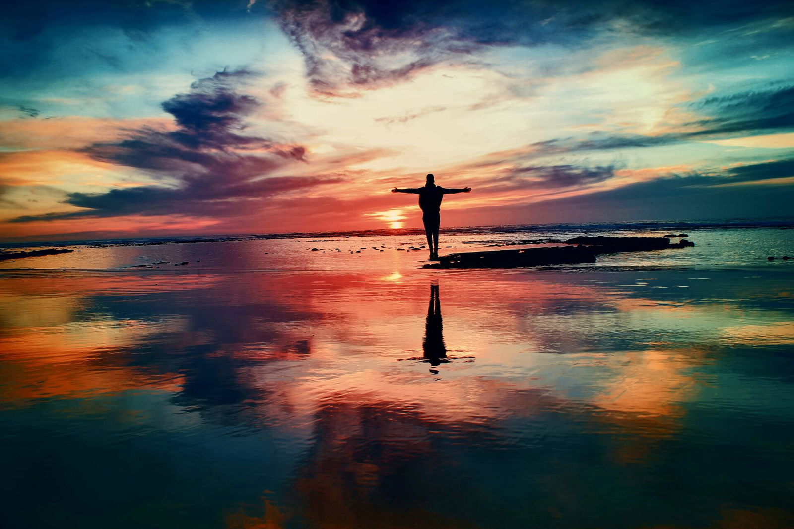 Person standing at sunset